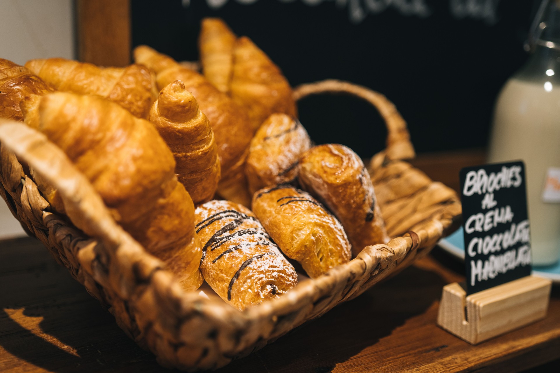 Baskets of fresh pastries on wooden table