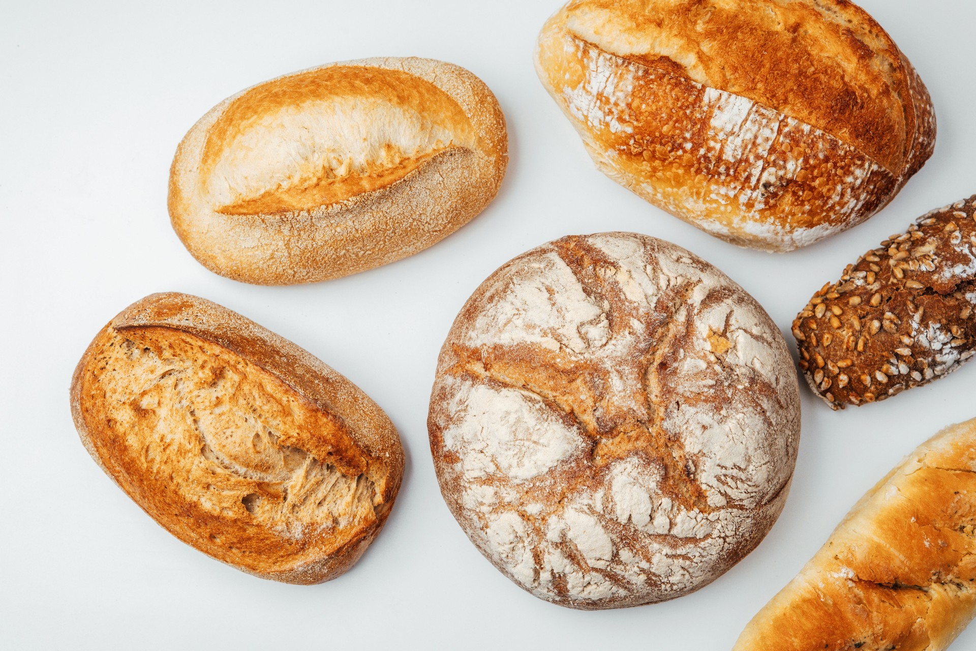 Freshly baked variety of artisan breads on a clean surface